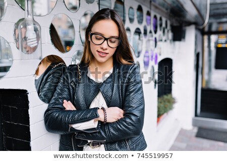 Foto d'archivio: Amazing Young Girl Brunette In Black Leather Jacket Posing