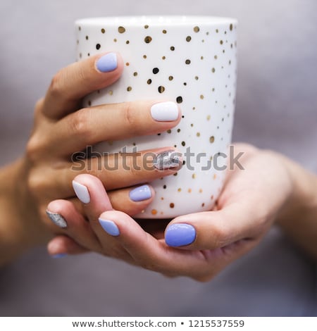 商業照片: Hand With A Stylish Gray Manicure Isolated On White Background