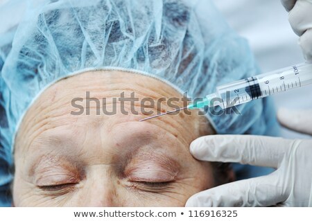 Foto stock: Elderly Woman Getting Botox Injection Procedure