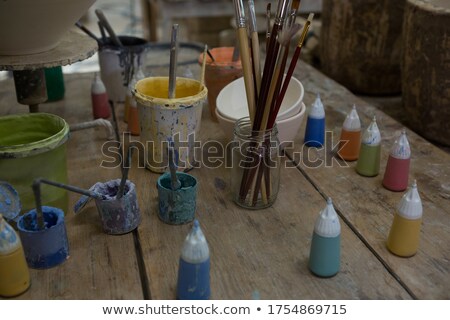 Stok fotoğraf: Watercolor Cans And Paintbrush In Pottery Workshop