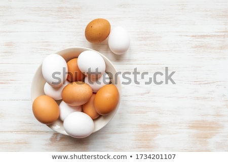 Foto stock: White And Brown Eggs Laying On White Plate On White Background