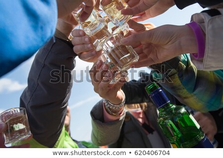 Stockfoto: Hands Of Alcoholic Drinking Vodka Shots At Night
