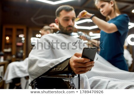Stock foto: Young Woman Visiting Young Handsome Barber
