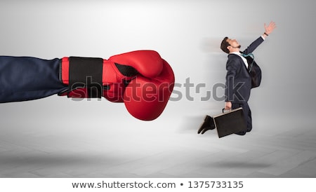 Foto stock: Giant Hand Gives A Kick To A Small Businessman