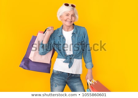 Foto stock: Senior Woman With Shopping Bags Isolated On White