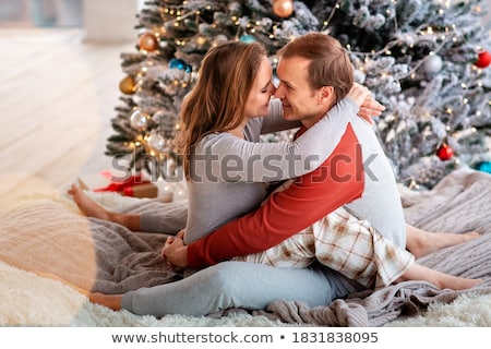 Foto d'archivio: Happy Couple Having Fun Near Chrismas Tree