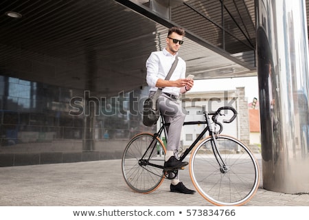 Foto stock: Man With Smartphone And Fixed Gear Bike On Street