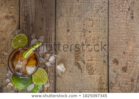 Foto stock: Glass Of Cold Cola With Citrus And Ice On Wooden Table Space Fo