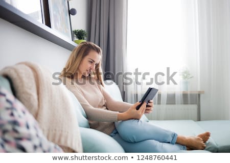 Foto stock: Young Woman Reading On Ebook