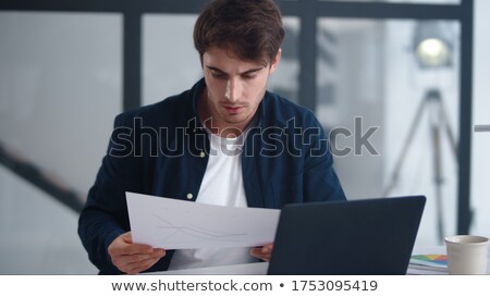 Foto stock: Concentrated Businessman Reading A Document