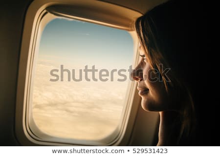 Stock fotó: Happy Young Woman Looking Through Window