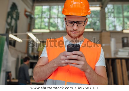 Stock fotó: Engineer Talking On Mobile Phone In Construction Site