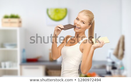 Stok fotoğraf: Happy Woman Eating Dark Chocolate Instead Of White