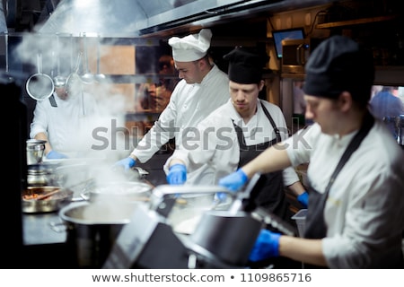 Foto stock: Group Of Chefs Standing In Kitchen At Hotel