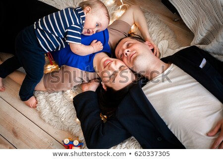 Happy Family Father Mother And Infant Lay On The Floor Imagine de stoc © Stasia04