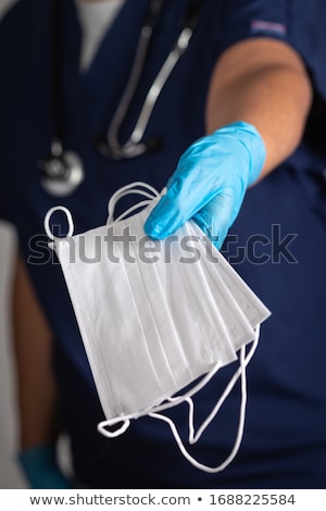 Foto stock: Female Doctor Or Nurse Wearing Surgical Gloves Holding A Few Med