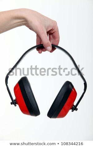 [[stock_photo]]: Hand Holding A Pair Of Ear Defenders