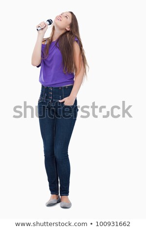 Foto stock: Teenager Raising Her Head While Singing With A Microphone