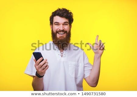 Stock fotó: Young Casual Man On His Phone Points Up