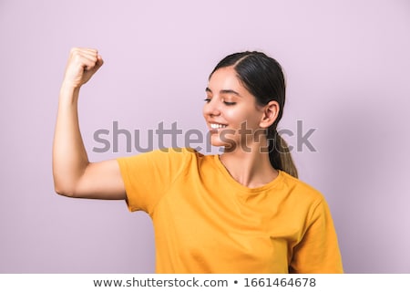 Stock photo: Pretty Woman Showing Her Biceps Against White