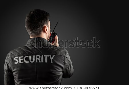 Foto stock: Security Guard Using Walkie Talkie