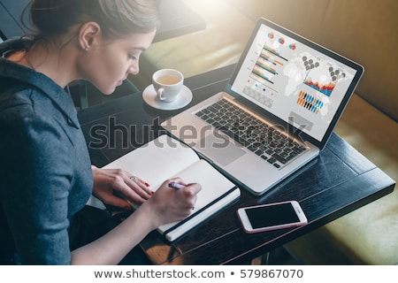 ストックフォト: Side View Of A Young Casual Woman Sitting