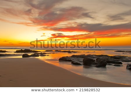 Stock photo: Beach Sunset Is A Sunset Sky With A Wave Rolling