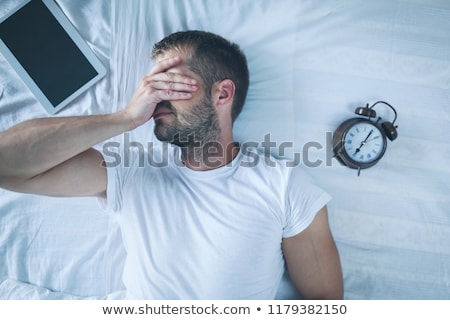 ストックフォト: Man Sleeping On Bed After Using His Digital Tablet