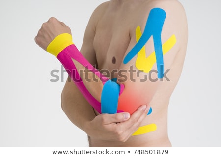 [[stock_photo]]: Kinesiology Tape On Mans Elbow