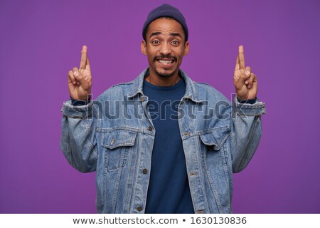 Foto stock: Cheerful Young Man In Casualwear Looking At Camera While Working Over New Music