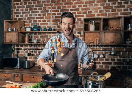 Stock photo: Man Cooking In Kitchen