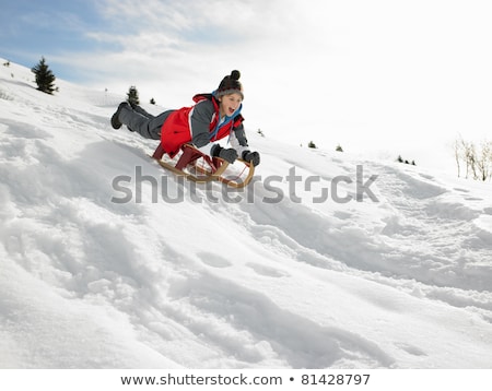 Foto stock: Pre Teen Boy On A Sled In The Snow