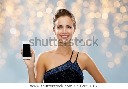 Stock fotó: Smiling Woman In Evening Dress Holding Smartphone