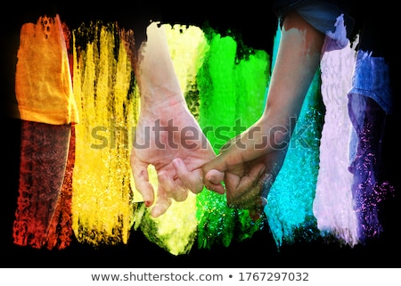 Stock photo: Close Up Of Male Gay Couple Hands On Rainbow Flag