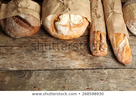 Foto d'archivio: Tasty Fresh Bread And Wheat On The Old Wooden Table