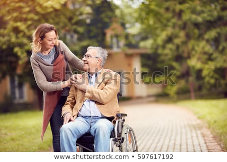 Stock photo: Hands Of An Old Woman And A Young Man Caring For The Elderly Close Up