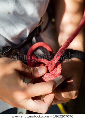 Foto stock: Climber Making A Knot