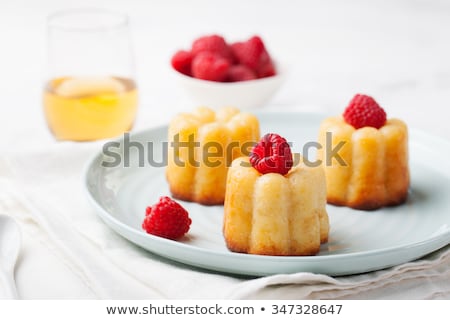 Foto stock: French Dessert Cakes Caneles Rum Baba With Fresh Raspberry