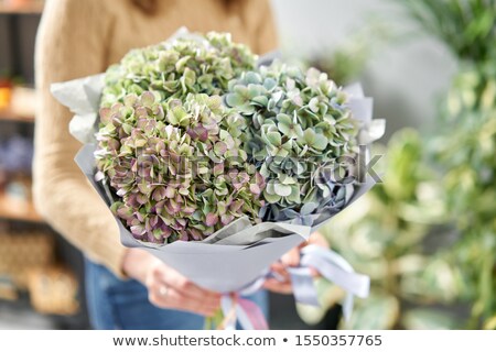 Stok fotoğraf: A Blue Vase With Fresh Flowers