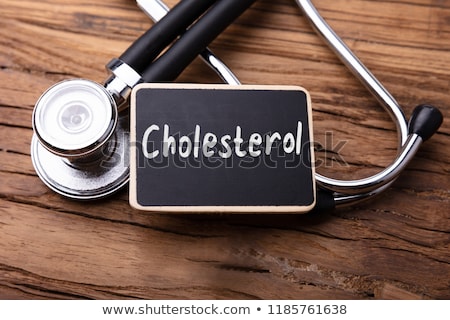 Foto stock: Cholesterol Word With Stethoscope On Wooden Table