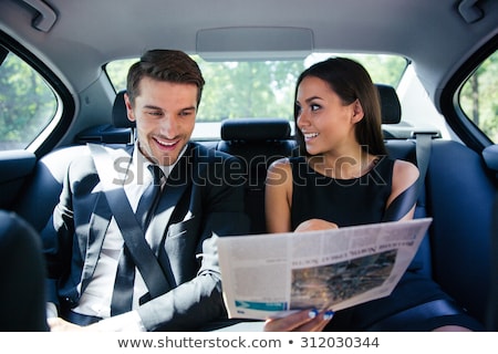 Stock fotó: Businesswoman Reading Newspaper In Car