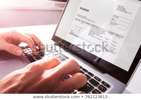 Zdjęcia stock: Businessman Checking Invoice On Laptop