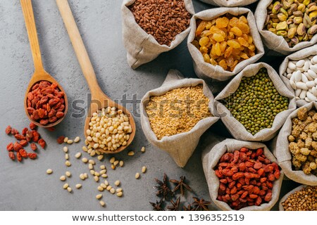 Stock foto: Small Sacks With Various Dried Fruit And Cereals Packed Two Wooden Spoons On Grey Background Healt