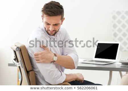 [[stock_photo]]: Man With Shoulder Pain Working On Laptop