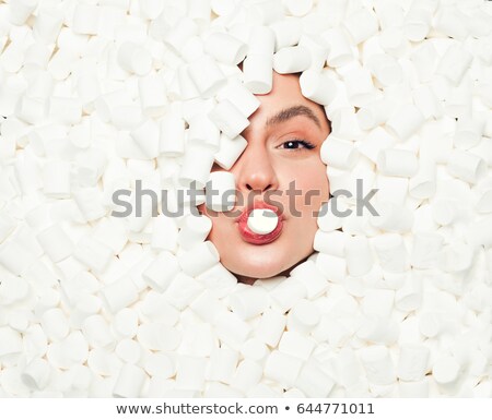 Foto d'archivio: Woman Biting In Marshmallow