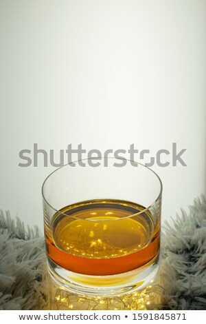 Foto stock: Whiskey With Ice Against Festive Lights Background