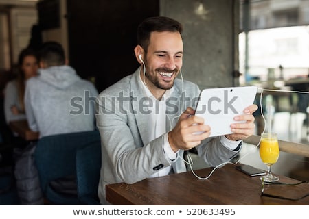 Foto stock: Happy Businessman In Formal Cloths Drinking Coffee And Reading News In The Kitchen