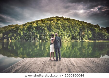 Stockfoto: Beautiful Young Couple Standing On A Pier