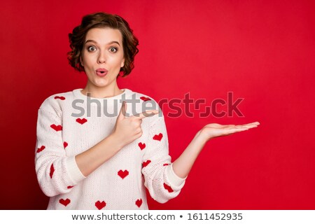 Stockfoto: Woman Pointing Finger To Her Lover Holding Heart Over Face