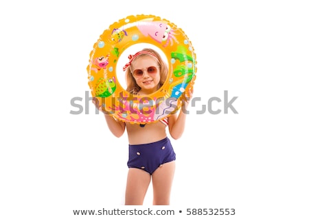 [[stock_photo]]: Beautiful Little Girl In In Red Striped Bikini Blue Bottoms And Red Wreath Sit On The Inflatable Se